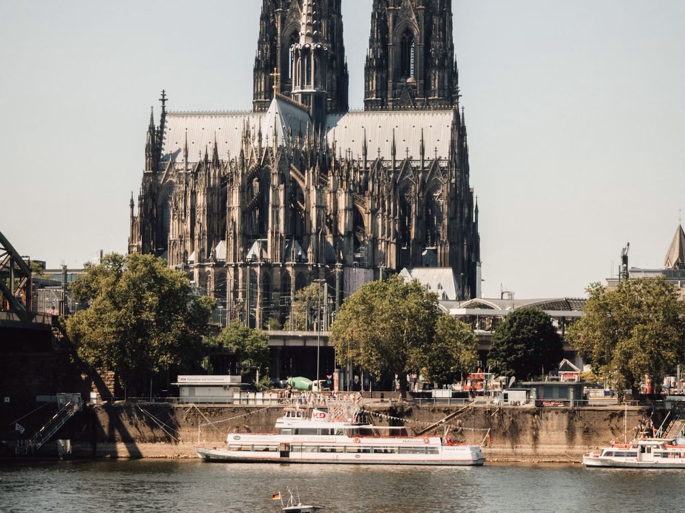 A river cruise boat on the Rhine beneath Cologne Cathedral in Germany